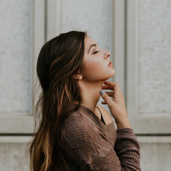 Serene young woman in side-profile portrait