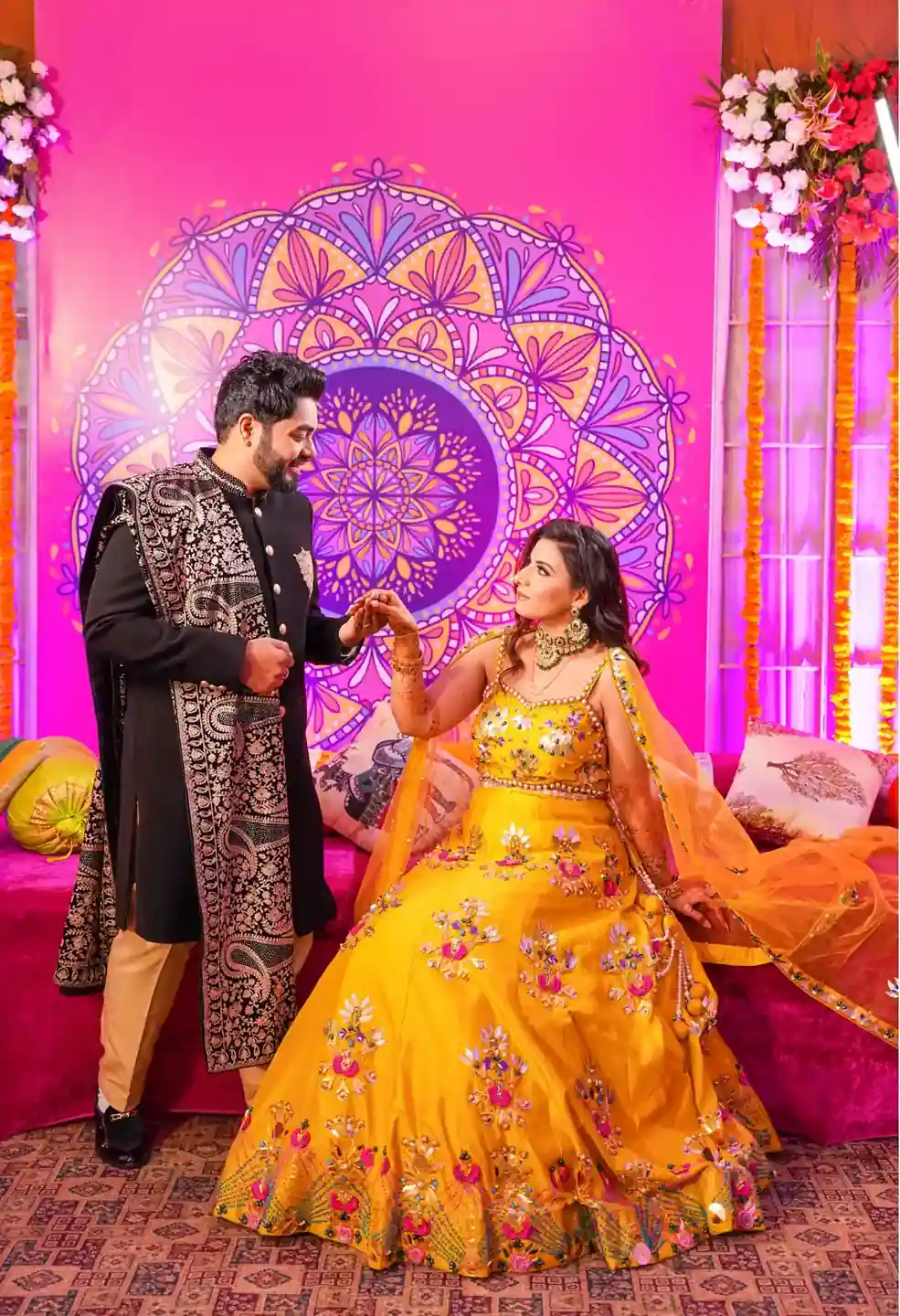 Joyful Indian couple embracing in ethnic attire during engagement photoshoot.