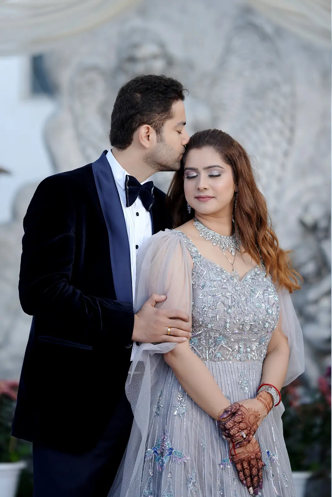 Engaged couple posing outdoors.
