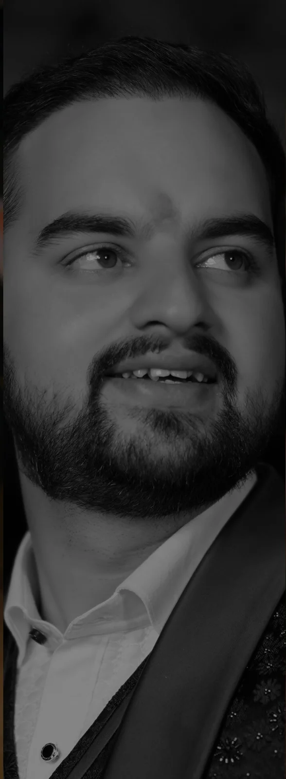 Indian couple in traditional attire gazing lovingly during romantic engagement photoshoot pose.