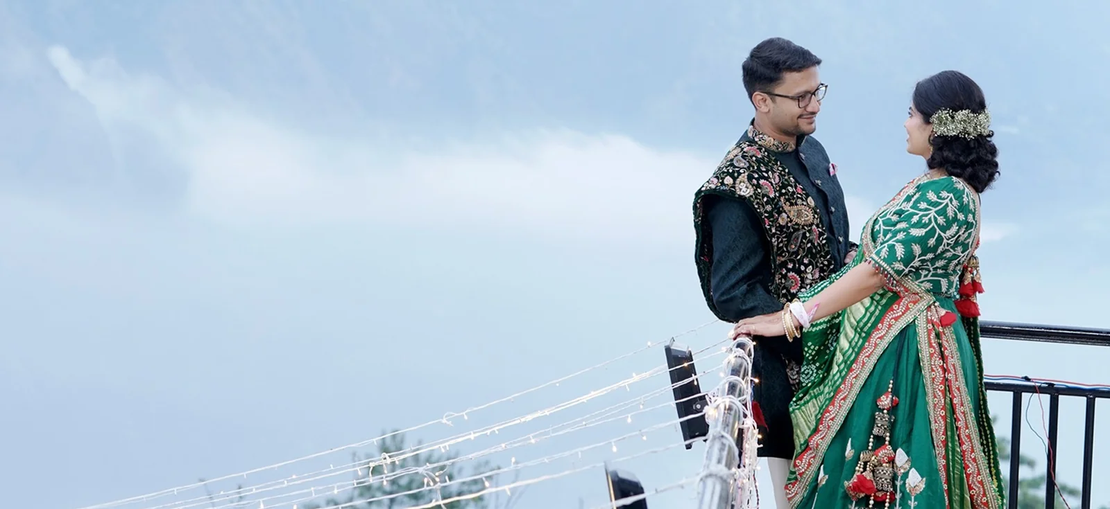 Engagement photoshoot featuring a couple posing in an outdoor setting