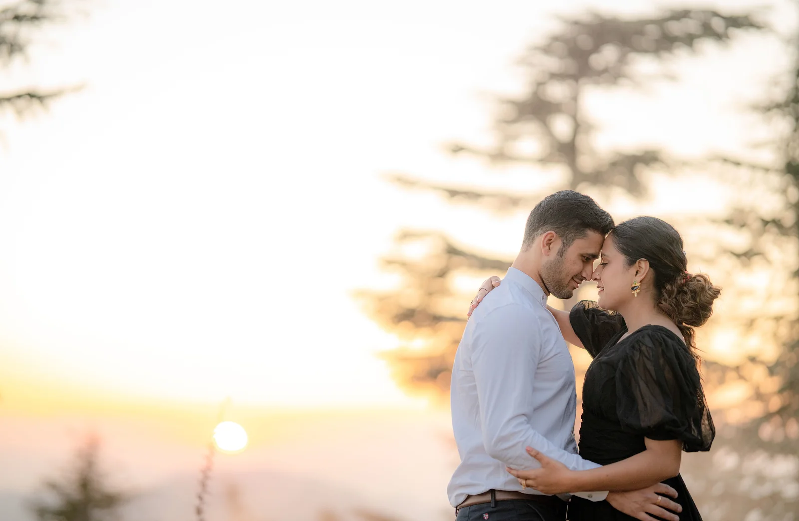 Pre-wedding couple posing together in a natural outdoor setting.