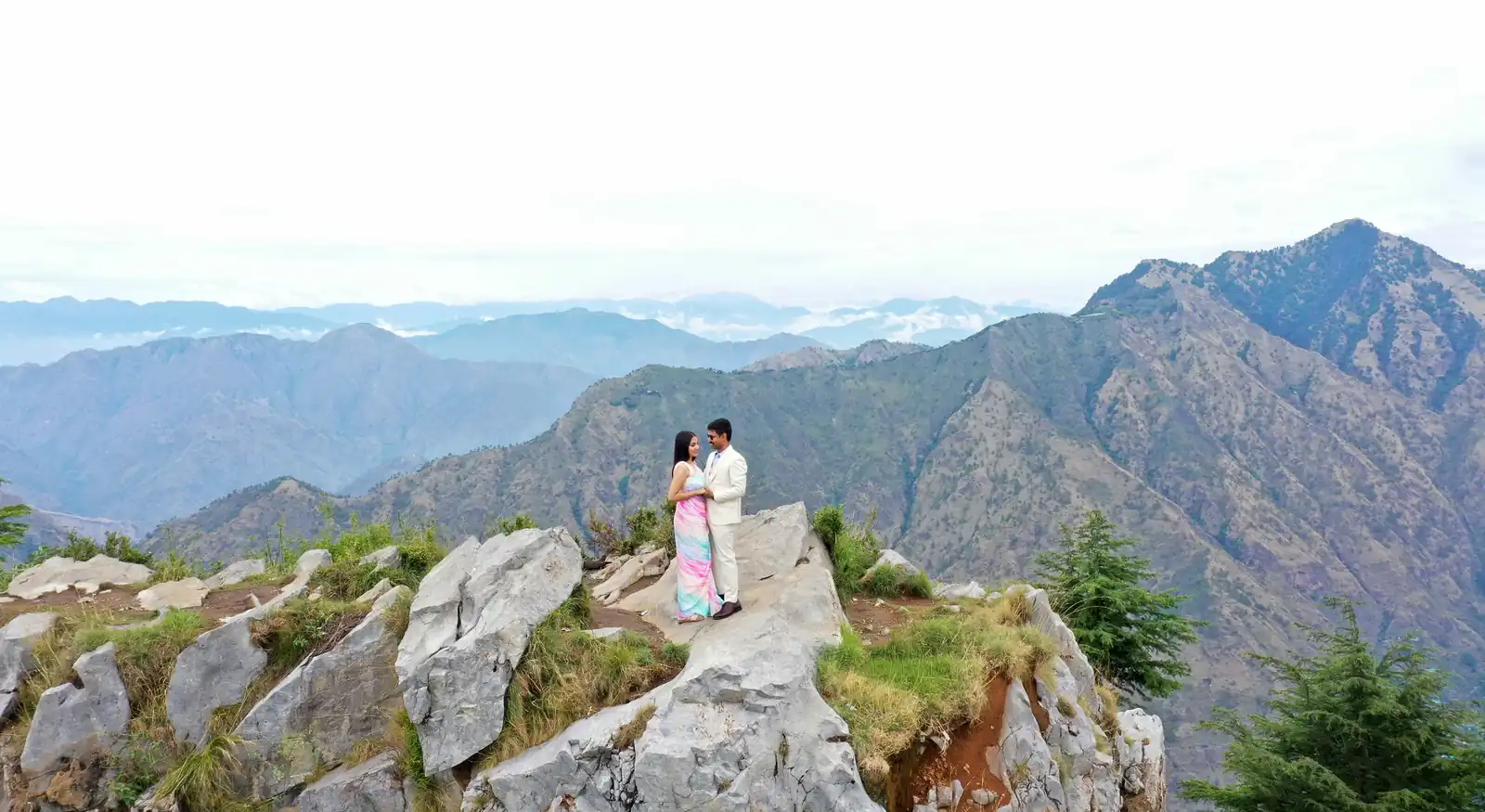 Pre-wedding couple posing in nature.