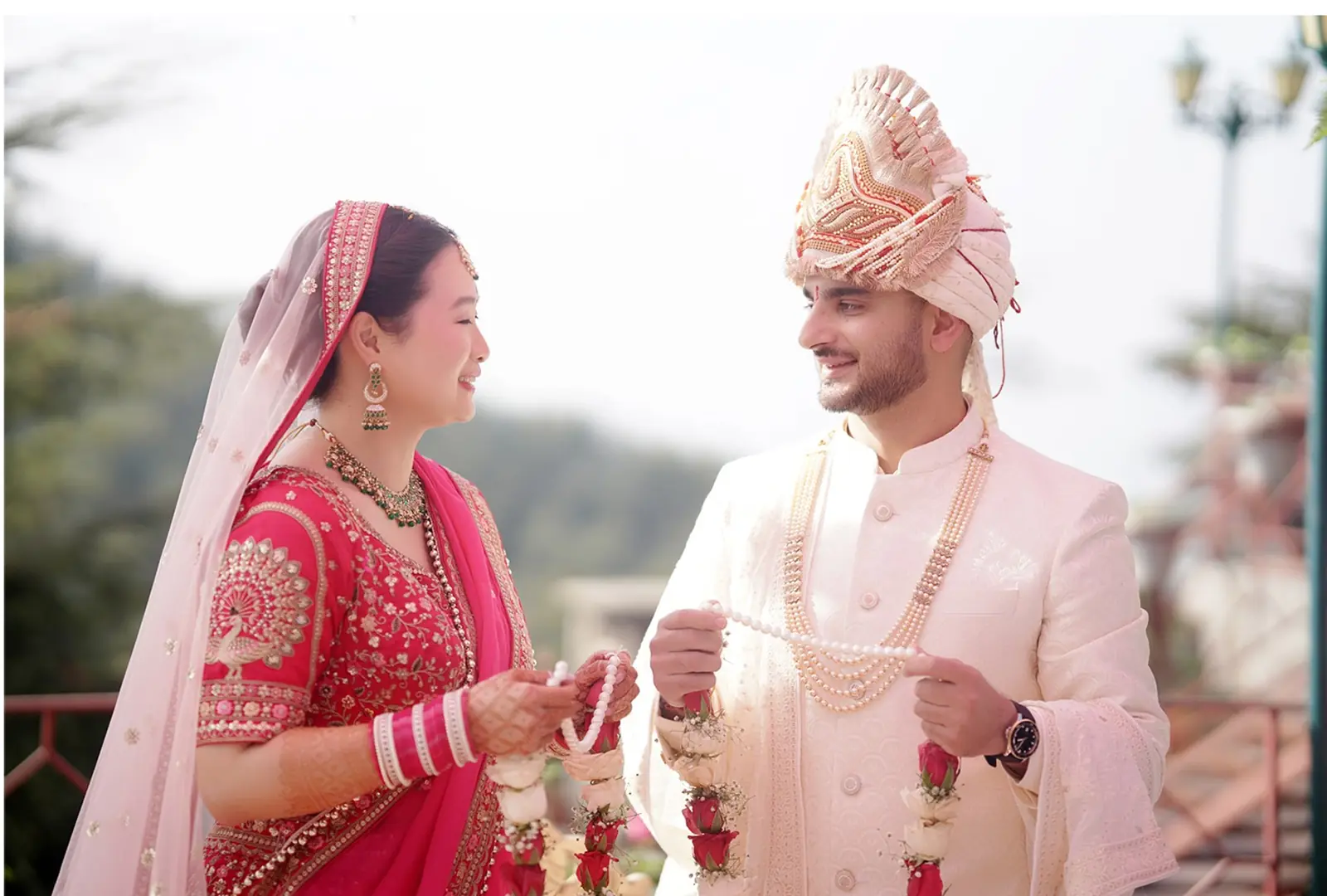 Bride and groom exchanging garlands at an Italian wedding venue.